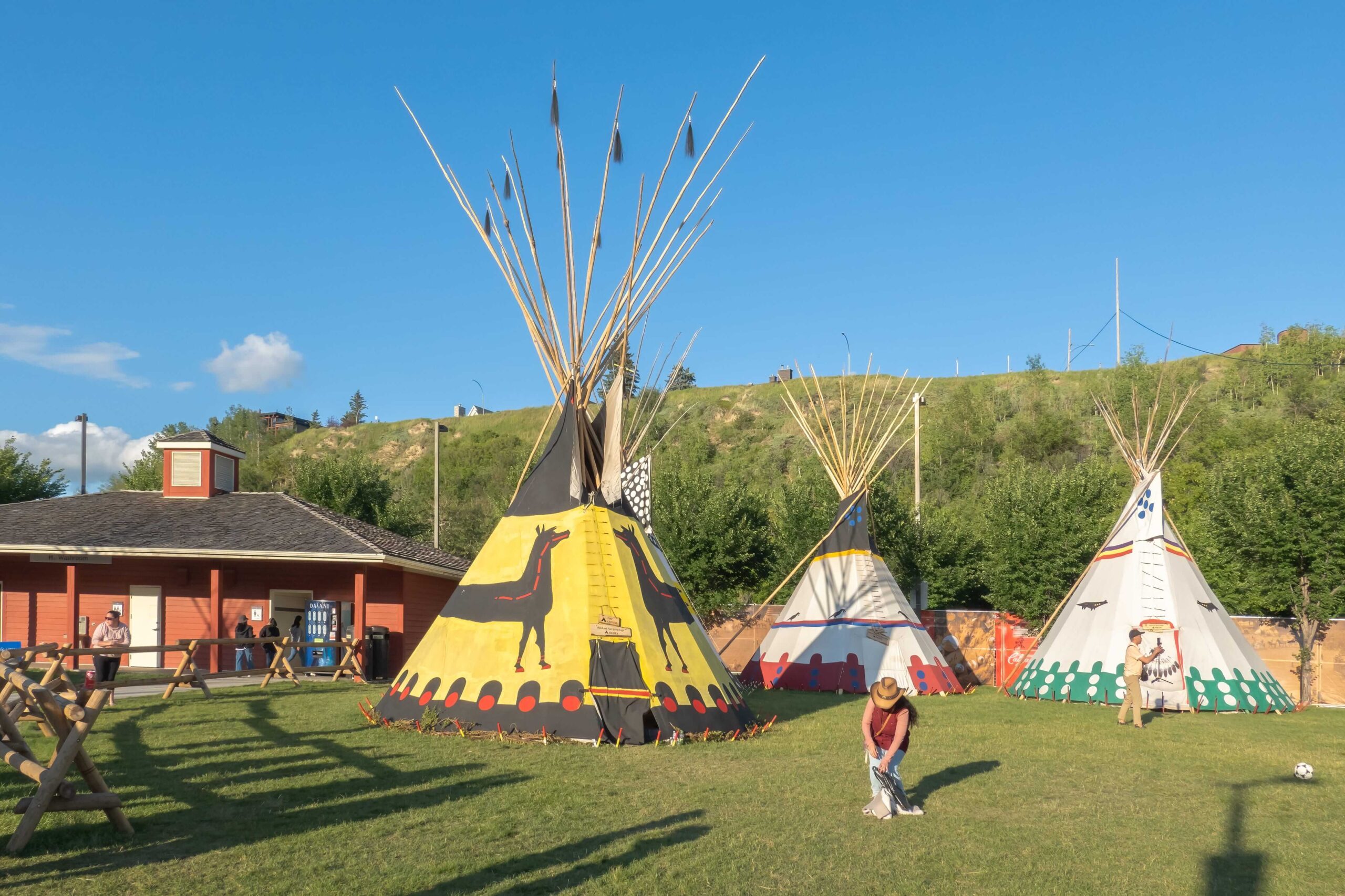 Colorful teepees at Elbow River Camp in Canada, reflecting Indigenous cultural traditions, community, and relationships to land.